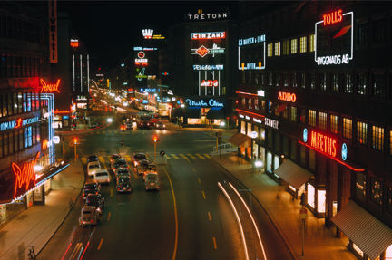 Vy över Kungsgatan med neonskyltar.
