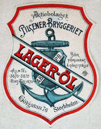Öletikett tryckt i blått, rött och svart med bild av ett ankare samt text.